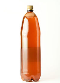 Close-up of orange bottle against white background