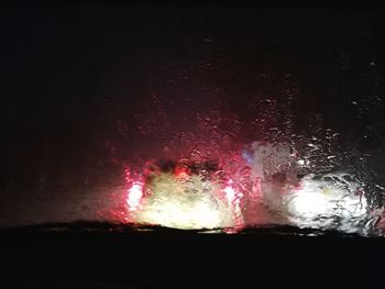 Close-up of illuminated car windshield at night