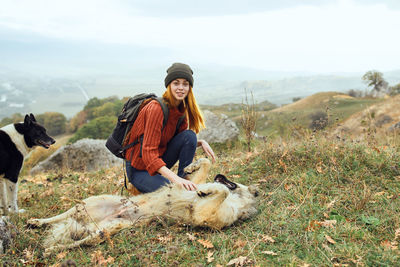 Full length of man with dog on field