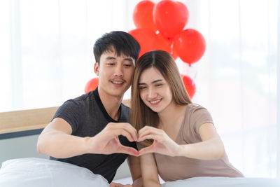 Portrait of a smiling young couple holding hands