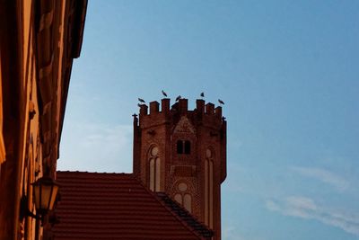 Low angle view of clock tower against clear sky