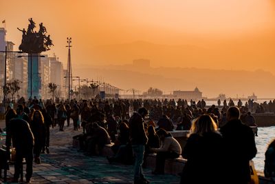 Crowd at town square during sunset