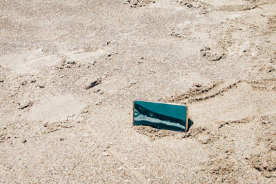 High angle view of chair on sand