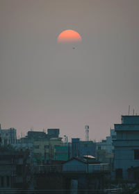 Low angle view of buildings against sky during sunset