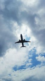 Low angle view of airplane in sky