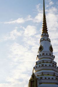 Low angle view of statue of temple against cloudy sky