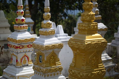 Traditional asian golden statutes in buddhist monastery phongsali, laos.