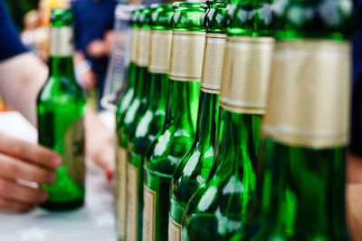 Close-up of beer bottles in row on table