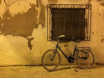 Bicycle parked in front of wall