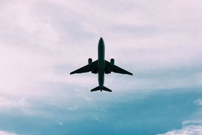 Low angle view of airplane flying in sky