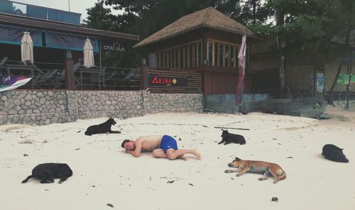 Full length of shirtless boy lying on floor