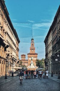 Group of people in front of buildings in city