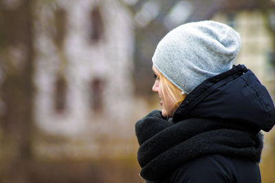 Woman wearing knit hat looking away