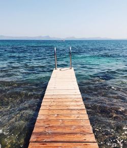 Pier over sea against clear sky