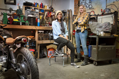 Portrait of happy female owners in auto repair shop