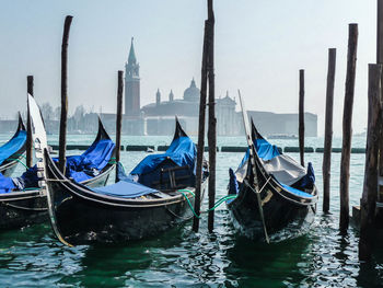 Gondolas moored in grand canal by santa maria della salute