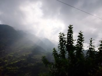 Scenic view of tree mountains against sky