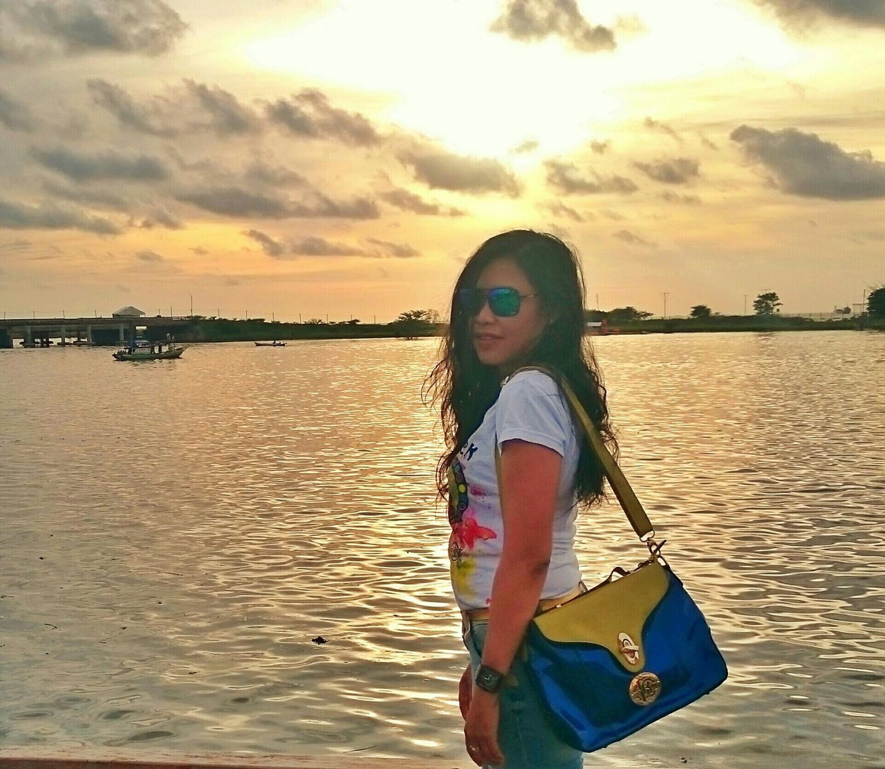 water, sky, lifestyles, sea, standing, leisure activity, cloud - sky, sunset, young adult, casual clothing, three quarter length, person, nautical vessel, cloud, transportation, outdoors, young women, beach