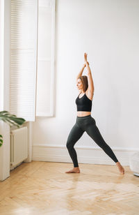 Full length of woman exercising in gym