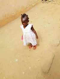 High angle view of cute girl on sand at beach