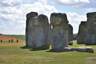 Rocks on field against sky