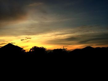 Silhouette landscape against sky during sunset