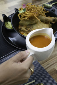 Close-up of hand holding coffee cup