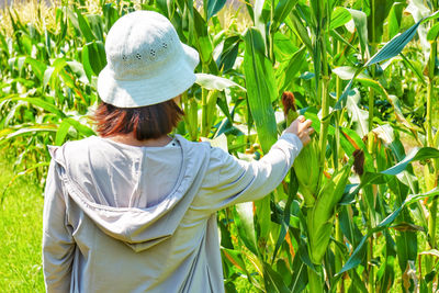 Rear view of woman standing in field