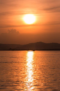 Scenic view of sea against romantic sky at sunset