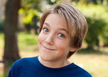 Close-up portrait of smiling boy in park