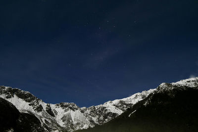 Low angle view of mountain against sky at night