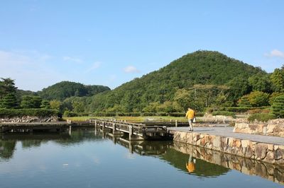 Scenic view of lake and mountains against sky