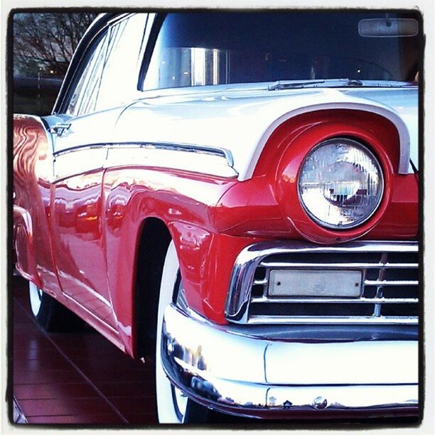 transportation, mode of transport, land vehicle, car, headlight, transfer print, travel, part of, vintage car, reflection, red, stationary, glass - material, street, close-up, auto post production filter, vehicle interior, window, no people, day