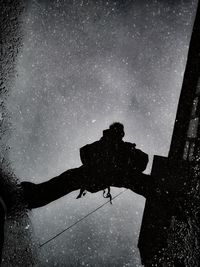 Low angle view of silhouette man against sky at night