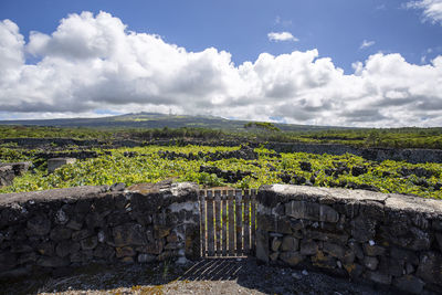 Scenic view of stone wall against sky