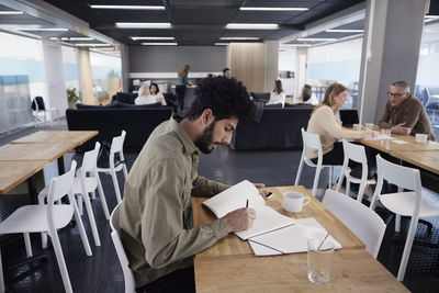 Man working solitary in office cafeteria