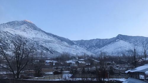 Scenic view of snowcapped mountains against clear sky