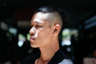 Close-up portrait of young man looking away