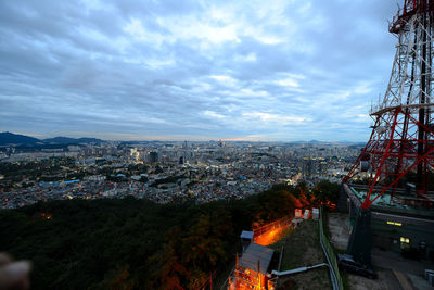 Cityscape against cloudy sky