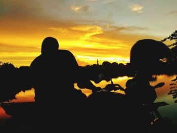 Silhouette people against sky during sunset