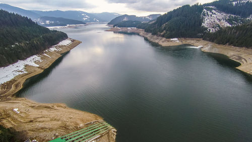 High angle view of river amidst mountains against sky