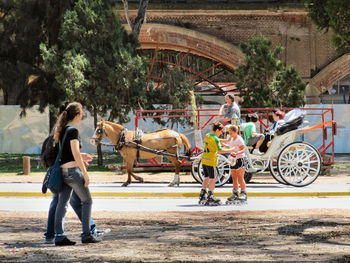 People with horse cart on street