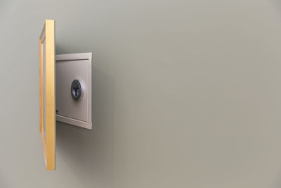 Close-up of telephone booth against wall