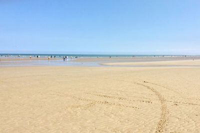 Scenic view of beach against blue sky