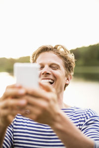 Portrait of happy woman using mobile phone