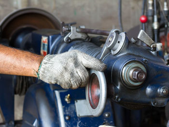 Cropped hand operating machinery in factory