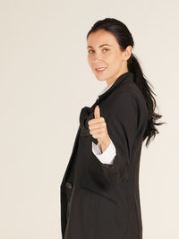 Portrait of a smiling young woman over white background