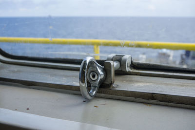 Stainless steel latch of a glass window on a construction work barge
