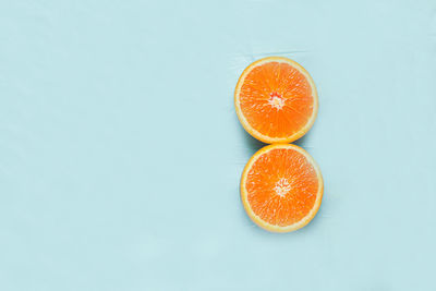 Close-up of orange fruit against white background