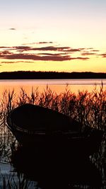 Scenic view of lake against orange sky